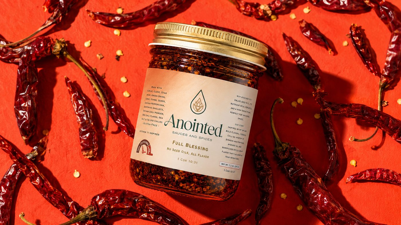 Full Blessing jar resting among dried red chilies on a vivid red backdrop
